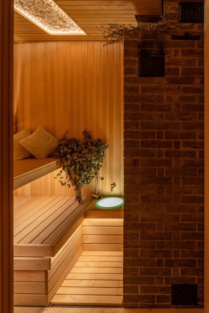 Experience Finnish sauna culture in Helsinki Traditional public sauna in Helsinki with locals enjoying a peaceful moment by the water.